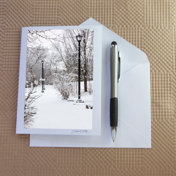christmas card of a snowy path and lamp posts by Laura Cook Vision Photgoraphy