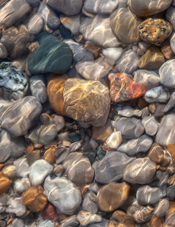Colourful Rocks under water with the suns reflections