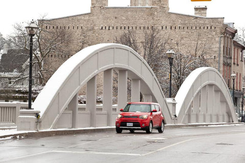 'Cambridge Soul' Photograph of Main Street Bridge in Galt, Cambridge in the winter with a red kia driving over the bridge photograph by Cambridge photographer Laura Cook 