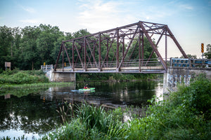 Paddling a Kayak Speed River under black bridge in Hespeler, Cambridge photo by Laura cook of Vision Photography 