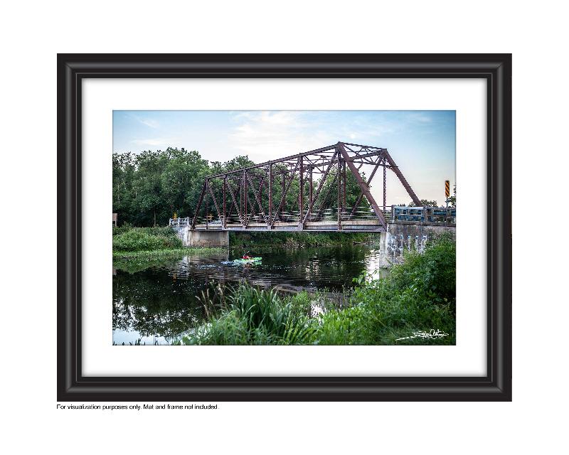 Paddling a kayak Speed River under black bridge in Hespeler, Cambridge photo by Laura cook of Vision Photography 