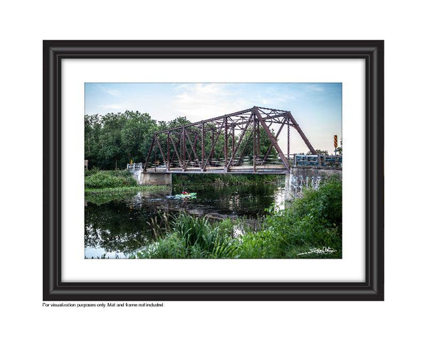 Paddling a kayak Speed River under black bridge in Hespeler, Cambridge photo by Laura cook of Vision Photography 